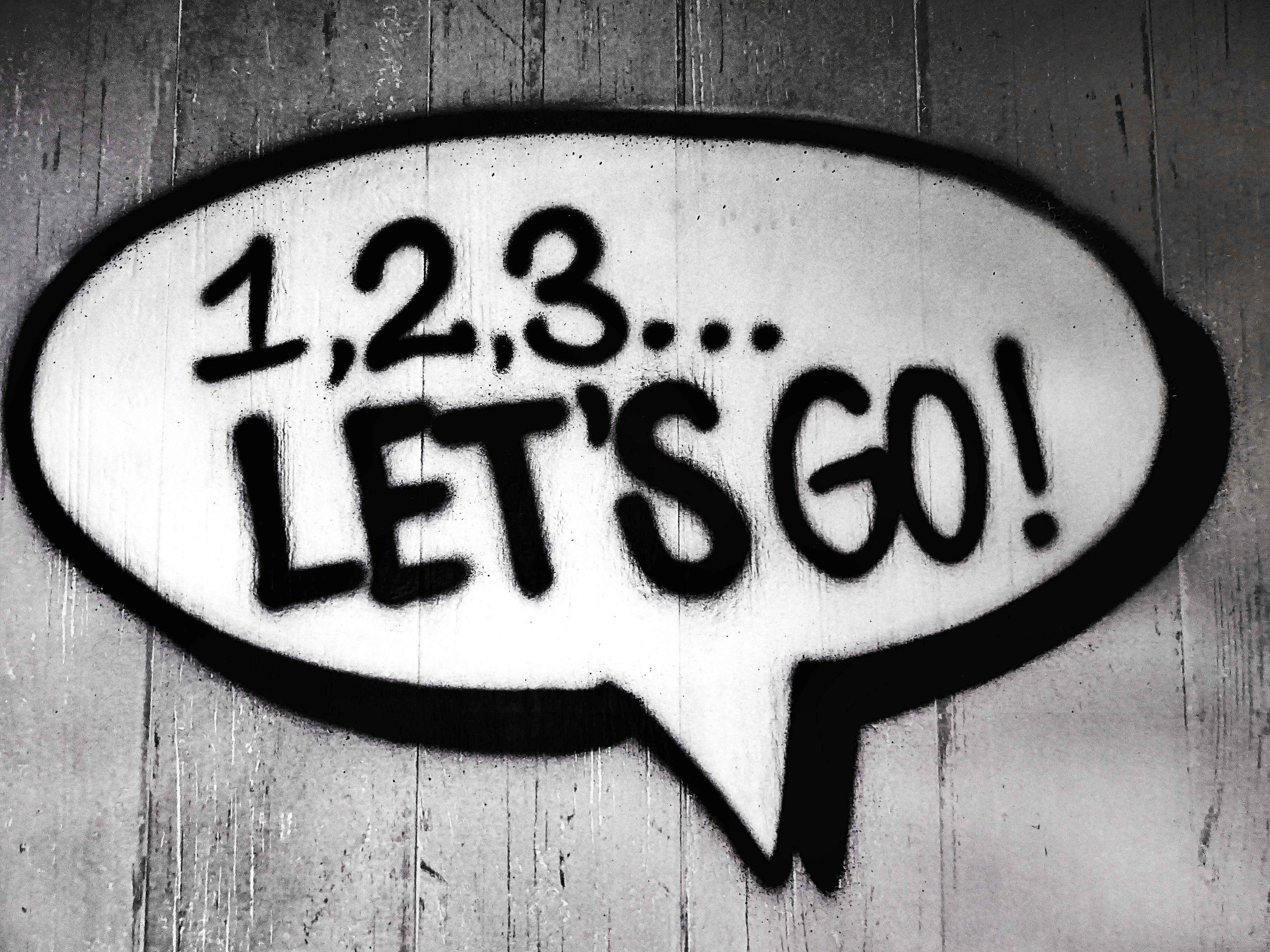 pexels-photo-704767-704767 Black and white street art featuring a bold motivational message in a speech bubble.
